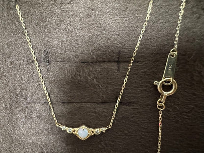 K10 Opal Necklace with opal and diamond accents set in K10 gold on a white background