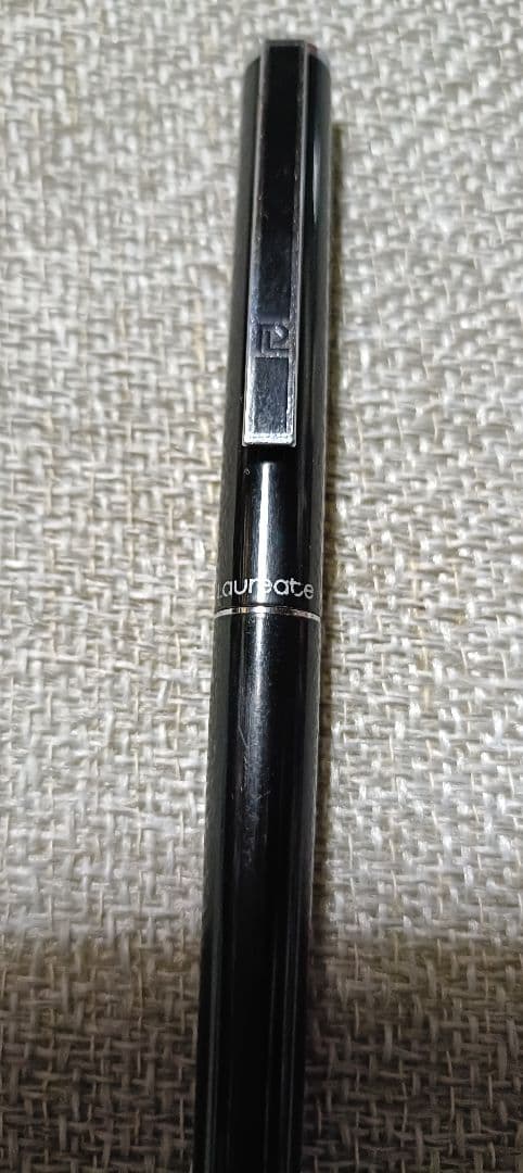 Pilot Laureate black and silver water-based ballpoint pen with cap on, showing light scratches and good condition