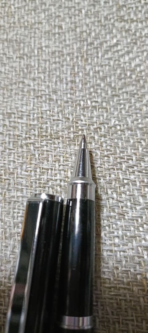 Pilot Laureate black and silver water-based ballpoint pen with cap on, showing light scratches and good condition