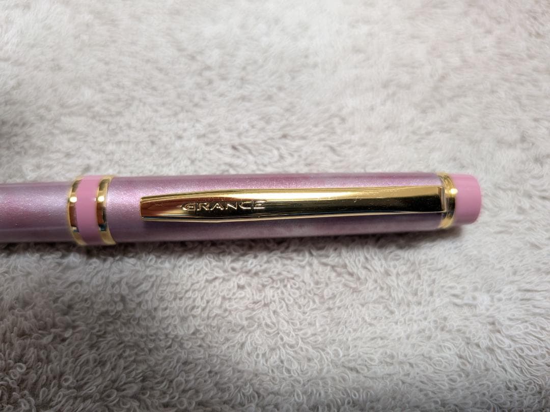 Pilot Grand Se Marble Pink ballpoint pen with gold accents and dedicated case on white background