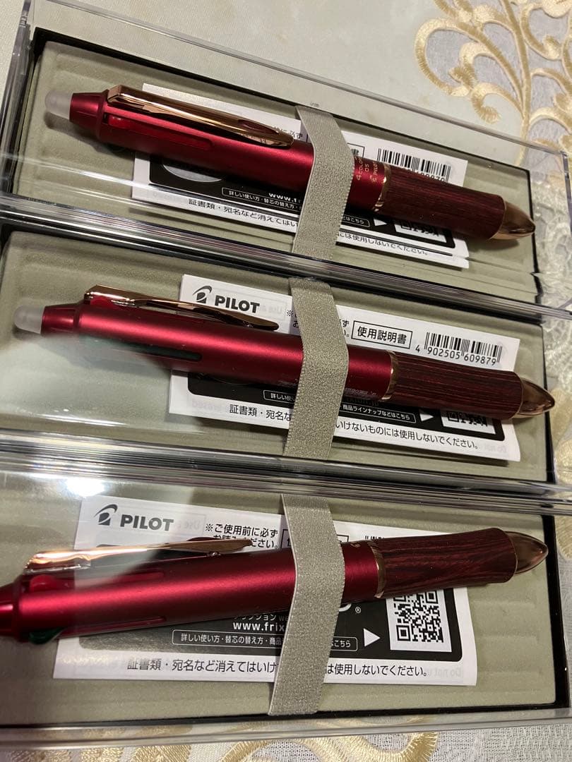 Set of three Pilot ballpoint pens in black, red, and blue with a black carrying case