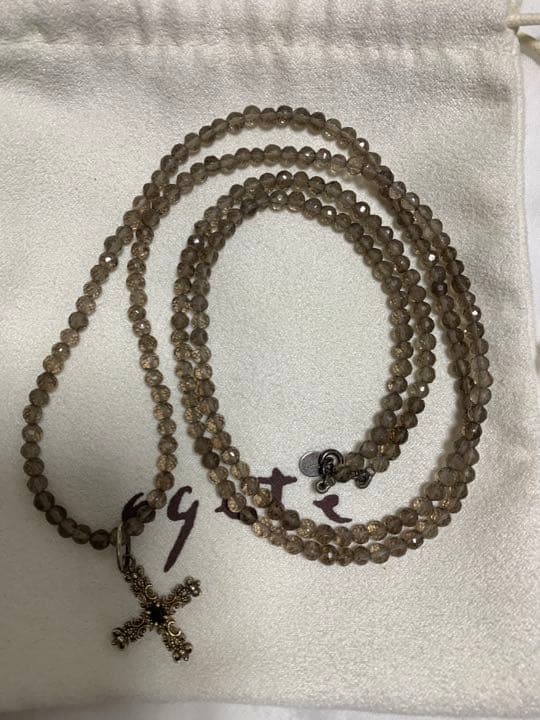 Light brown transparent smoky quartz necklace with gold cross pendant and silver top set