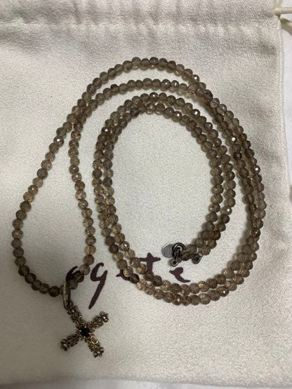Light brown transparent smoky quartz necklace with gold cross pendant and silver top set