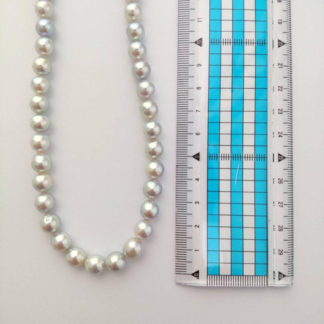 Akoya pearl necklace with natural gray 8-8.5mm round pearls and silver clasp on a white background