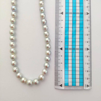 Akoya pearl necklace with natural gray 8-8.5mm round pearls and silver clasp on a white background
