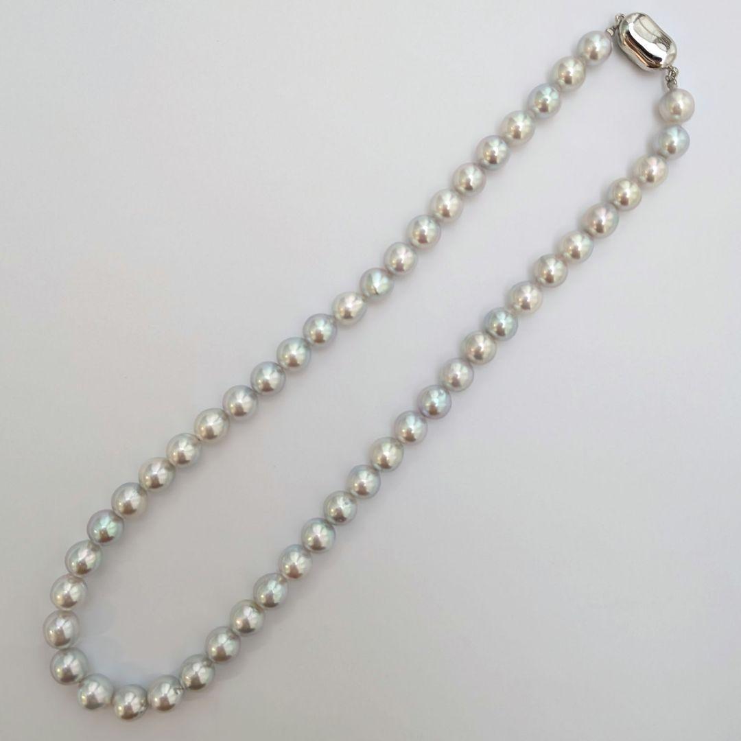 Akoya pearl necklace with natural gray 8-8.5mm round pearls and silver clasp on a white background