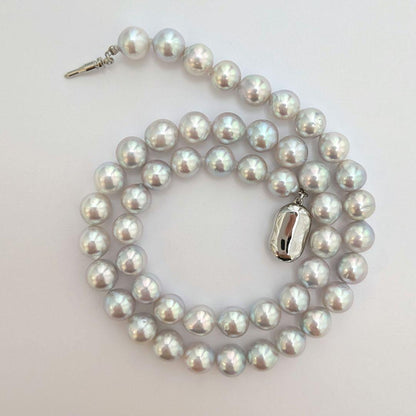 Akoya pearl necklace with natural gray 8-8.5mm round pearls and silver clasp on a white background