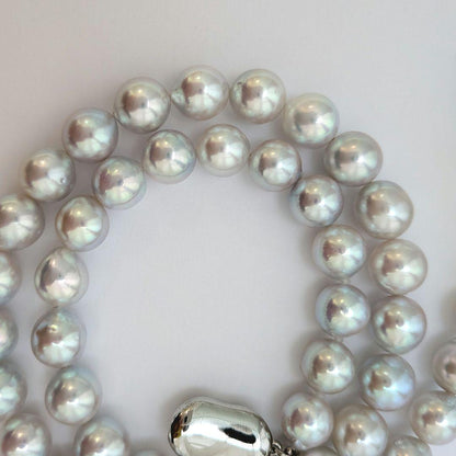 Akoya pearl necklace with natural gray 8-8.5mm round pearls and silver clasp on a white background