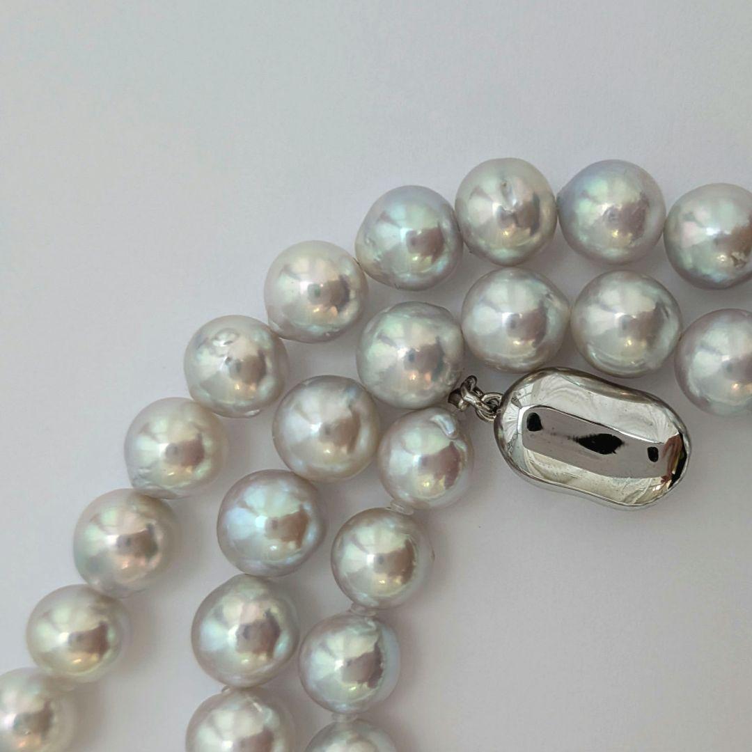 Akoya pearl necklace with natural gray 8-8.5mm round pearls and silver clasp on a white background