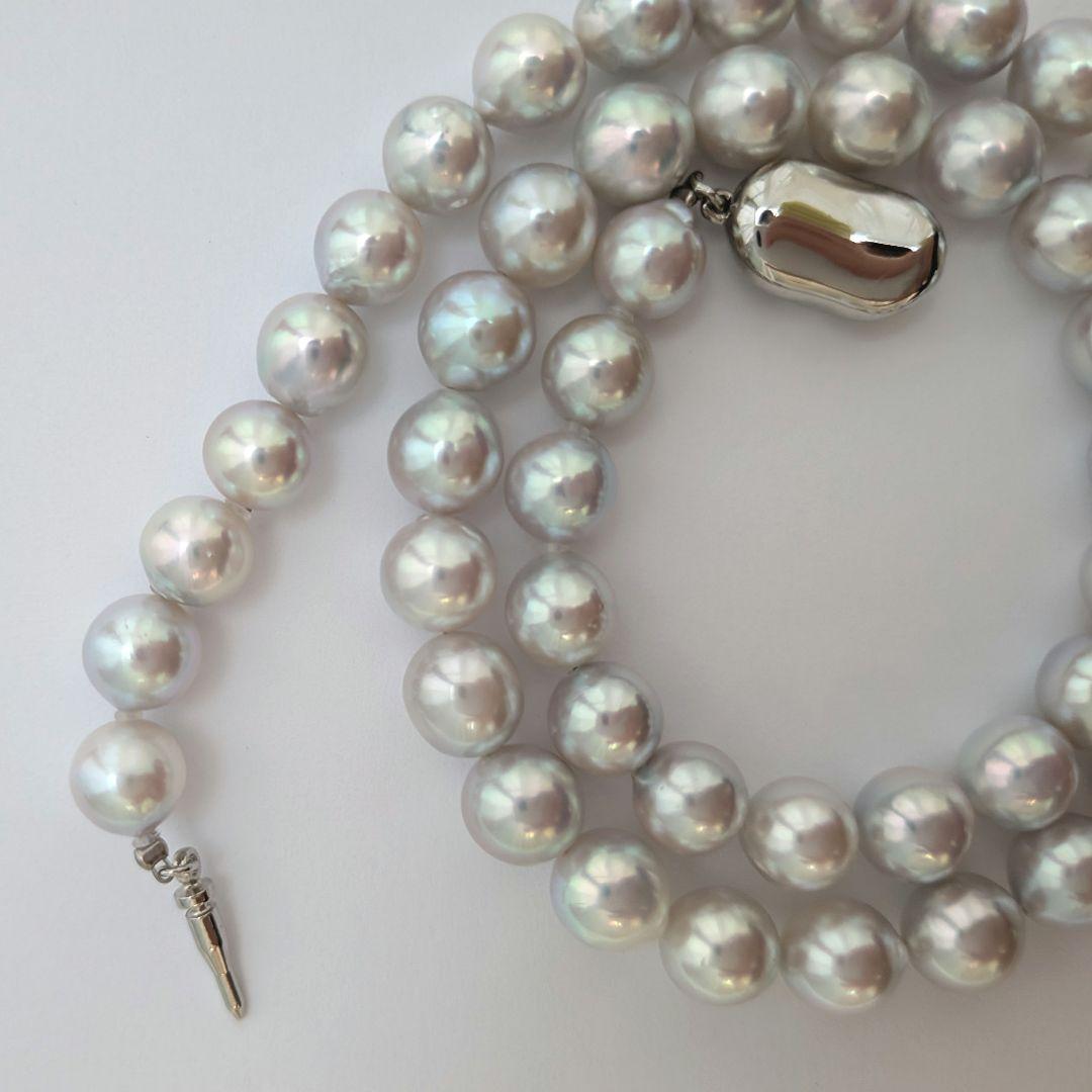Akoya pearl necklace with natural gray 8-8.5mm round pearls and silver clasp on a white background
