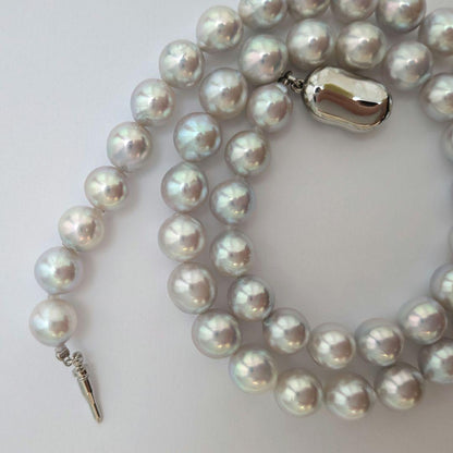 Akoya pearl necklace with natural gray 8-8.5mm round pearls and silver clasp on a white background