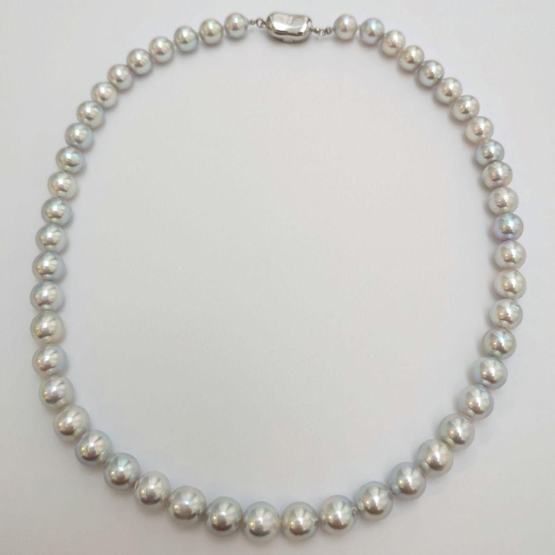 Akoya pearl necklace with natural gray 8-8.5mm round pearls and silver clasp on a white background