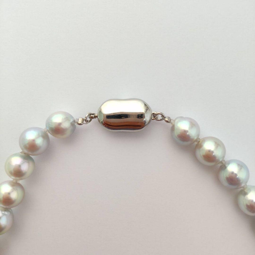 Akoya pearl necklace with natural gray 8-8.5mm round pearls and silver clasp on a white background