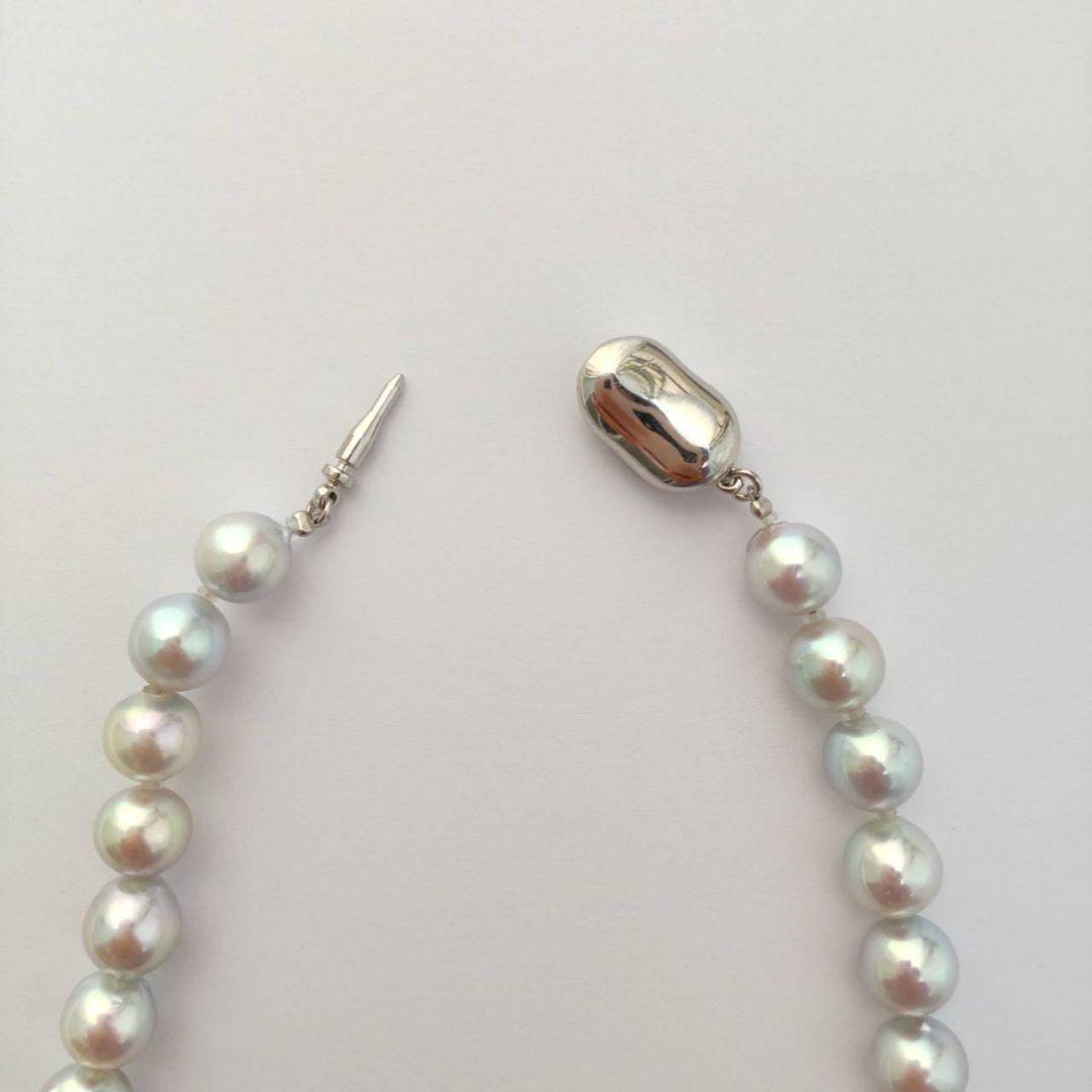 Akoya pearl necklace with natural gray 8-8.5mm round pearls and silver clasp on a white background