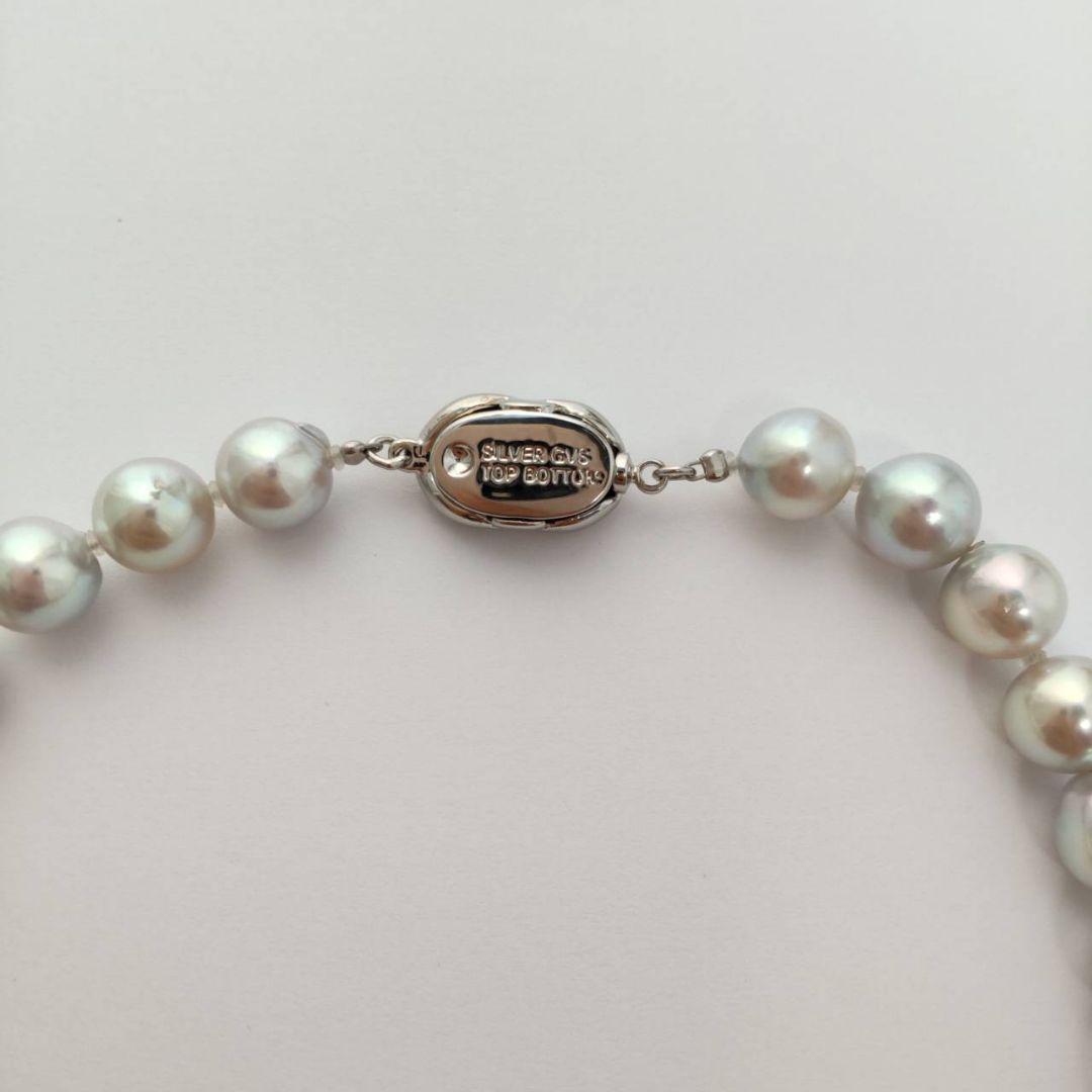 Akoya pearl necklace with natural gray 8-8.5mm round pearls and silver clasp on a white background