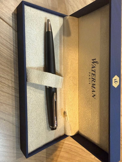 Waterman Expert Essential Matte Black CT ballpoint pen with matte finish and silver trim, shown with included paper bag