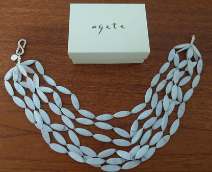 Close-up of a new Agate Shell Necklace featuring natural shell beads and elegant design