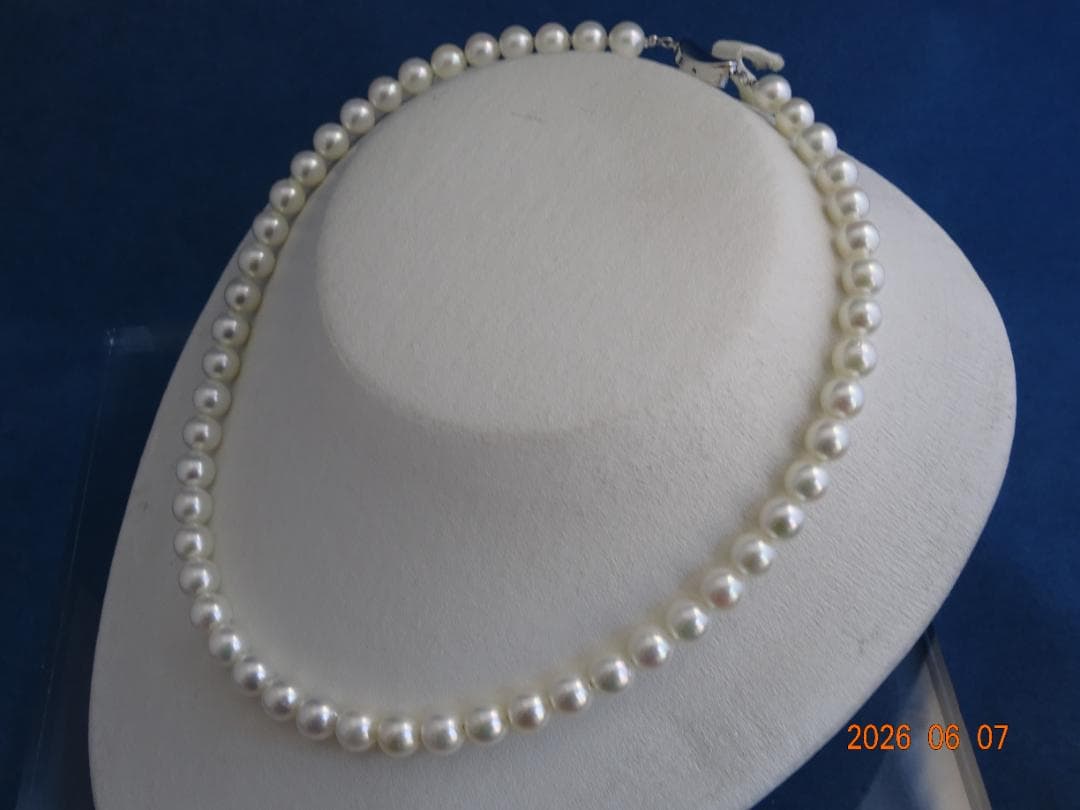 Akoya pearl necklace featuring almost round 7.5-8mm white, pink, blue, and cream pearls with silver clasp