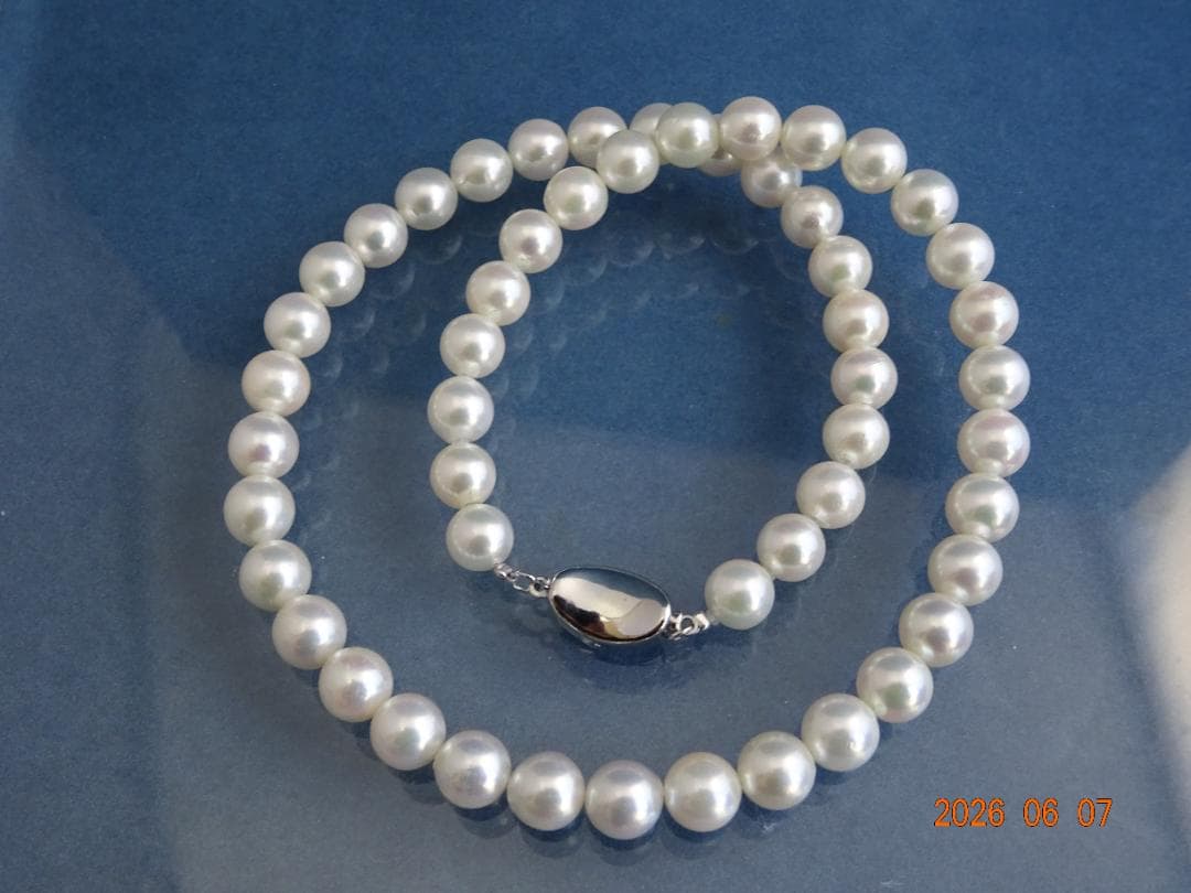 Akoya pearl necklace featuring almost round 7.5-8mm white, pink, blue, and cream pearls with silver clasp