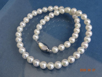 Akoya pearl necklace featuring almost round 7.5-8mm white, pink, blue, and cream pearls with silver clasp