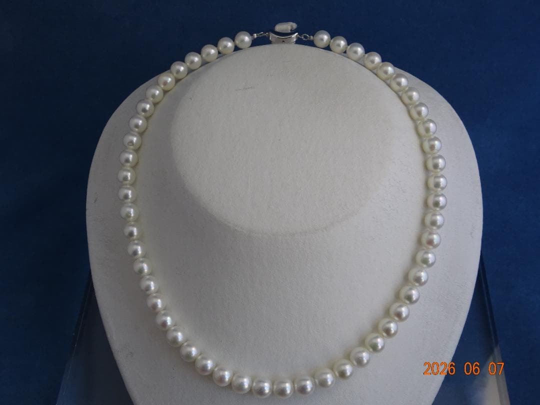 Akoya pearl necklace featuring almost round 7.5-8mm white, pink, blue, and cream pearls with silver clasp