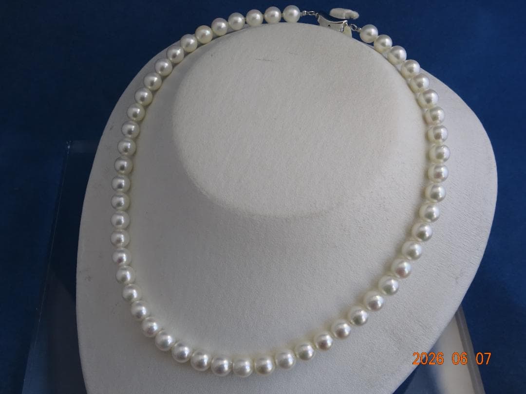 Akoya pearl necklace featuring almost round 7.5-8mm white, pink, blue, and cream pearls with silver clasp