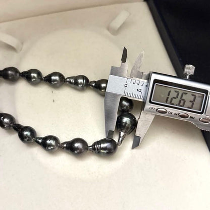 Aurora black-lipped pearl necklace with round peacock green Akoya pearls measuring 8.6-12.6mm on 43 cm silver chain