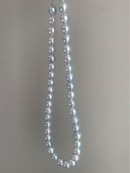 Akoya pearl necklace with natural blue pearls sized 9 to 10 millimeters arranged on a white background