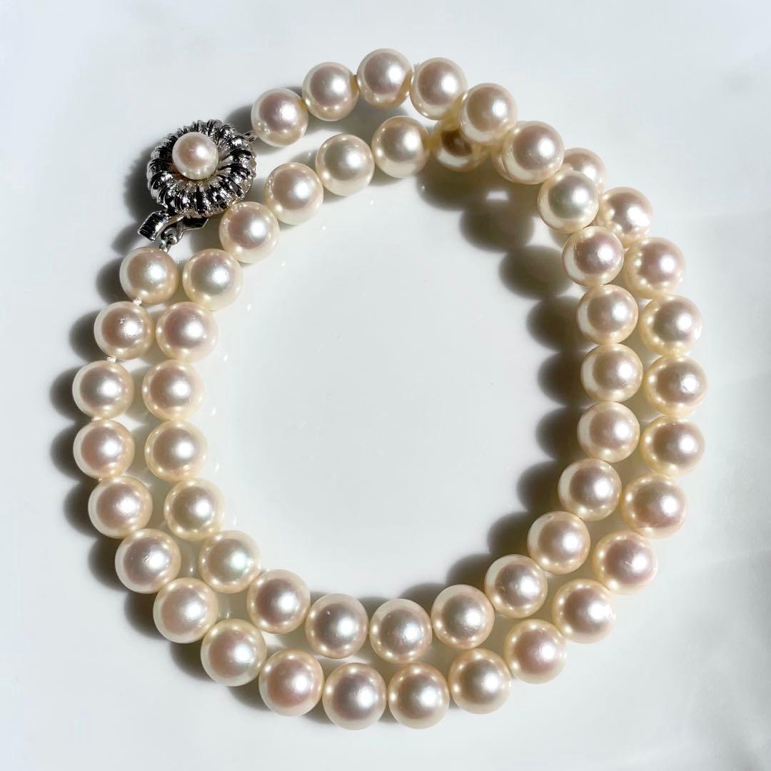 Akoya pearl necklace with 7.5-8mm white pearls and silver clasp displayed on a white background