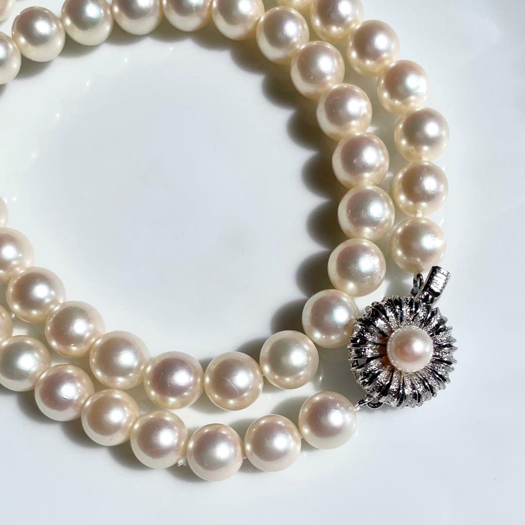 Akoya pearl necklace with 7.5-8mm white pearls and silver clasp displayed on a white background