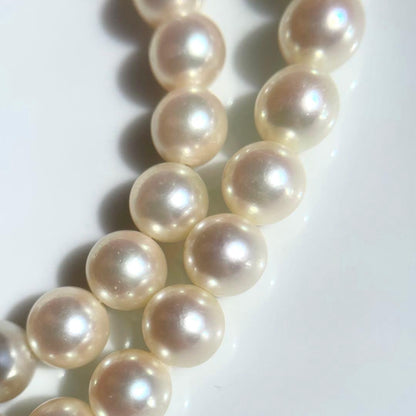 Akoya pearl necklace with 7.5-8mm white pearls and silver clasp displayed on a white background
