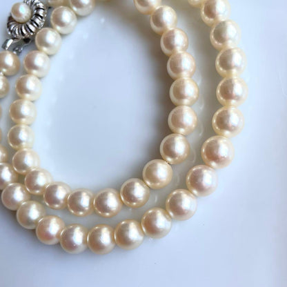 Akoya pearl necklace with 7.5-8mm white pearls and silver clasp displayed on a white background