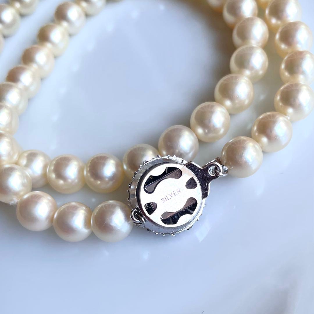 Akoya pearl necklace with 7.5-8mm white pearls and silver clasp displayed on a white background