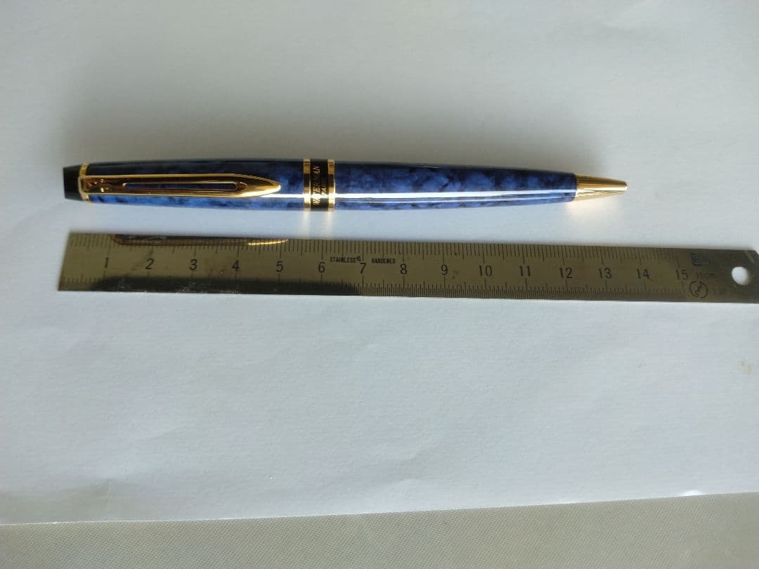 Waterman ballpoint pen in blue marble pattern with gold trim and twist mechanism, displayed with dedicated case