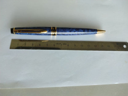 Waterman ballpoint pen in blue marble pattern with gold trim and twist mechanism, displayed with dedicated case
