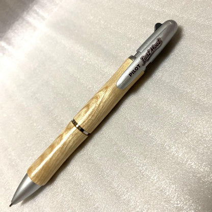 PILOT JustMeet wooden multi-function pen with three colors and mechanical pencil on a white background
