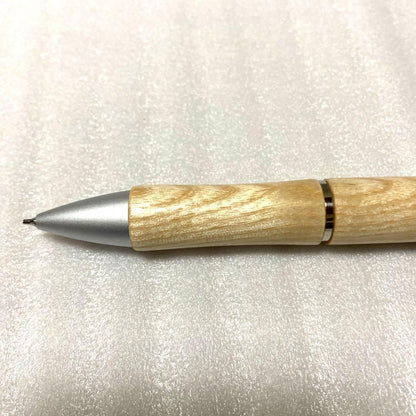 PILOT JustMeet wooden multi-function pen with three colors and mechanical pencil on a white background