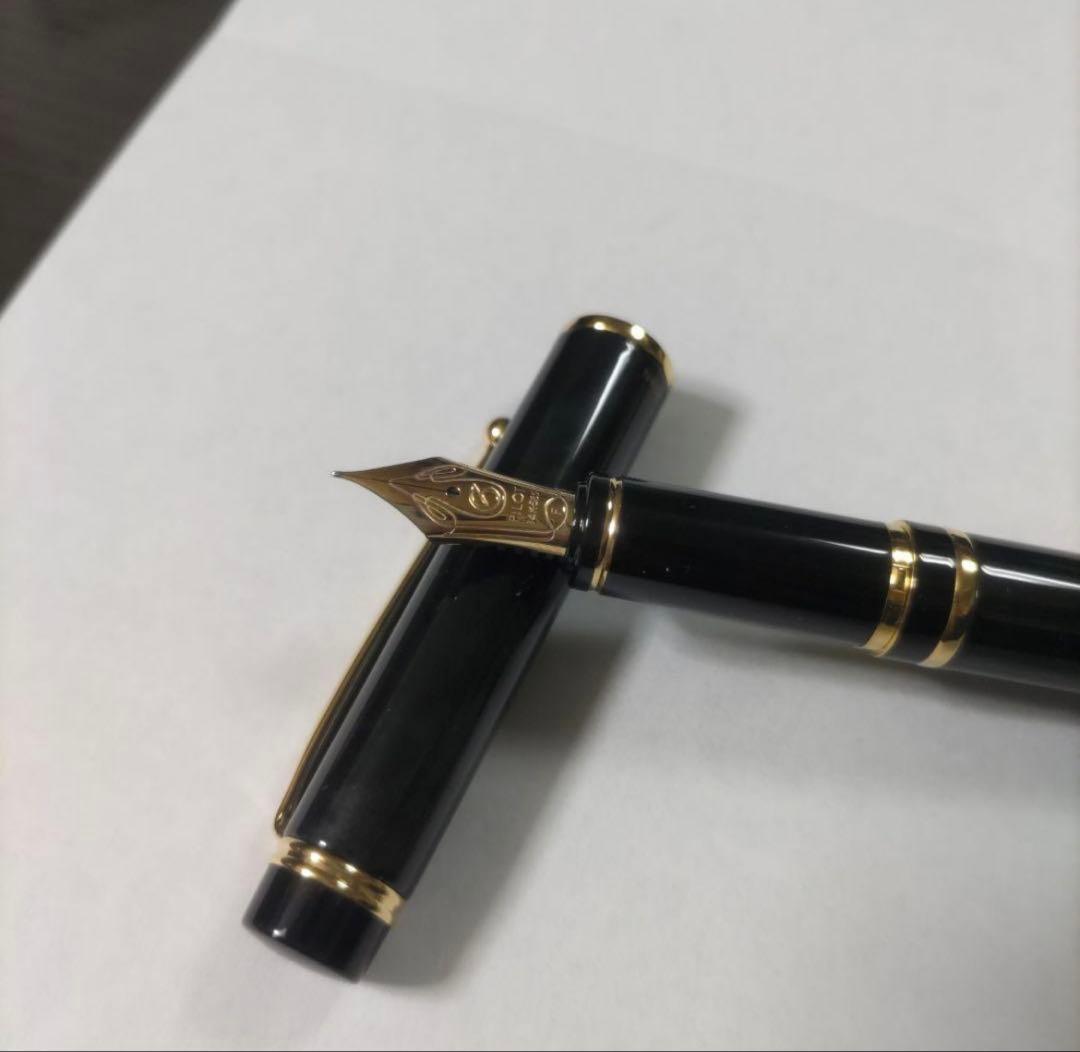 New Pilot Graice fountain pen in black and gold with 14k gold nib shown uncapped and writing
