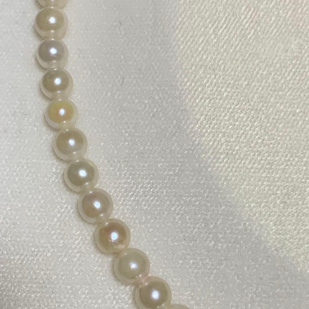Akoya pearl necklace with 43 cm length and 6.1 to 5.5 mm round pearls on white background
