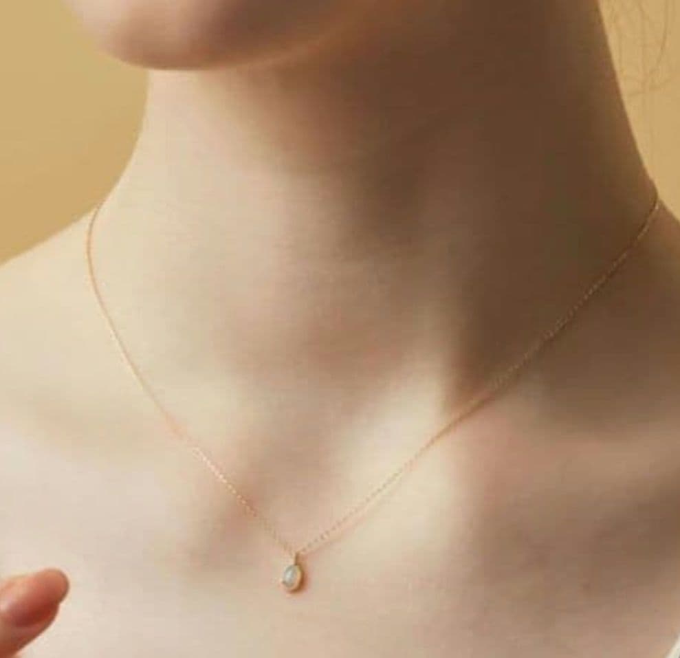 Current Model Agate K10 necklace with opal pendant measuring 0.6 by 0.4 cm on 40 cm gold chain