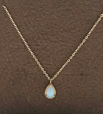 Current Model Agate K10 necklace with opal pendant measuring 0.6 by 0.4 cm on 40 cm gold chain