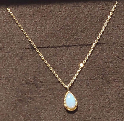Current Model Agate K10 necklace with opal pendant measuring 0.6 by 0.4 cm on 40 cm gold chain