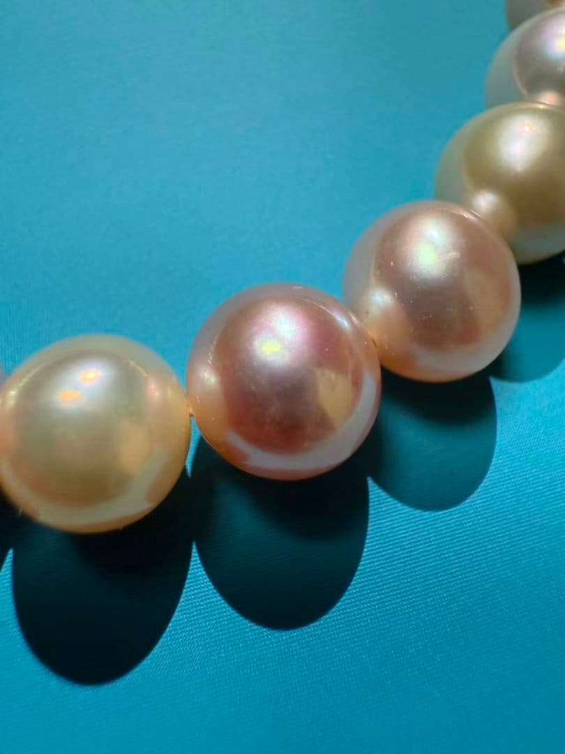 Close-up of a single lustrous Akoya pearl on a white background