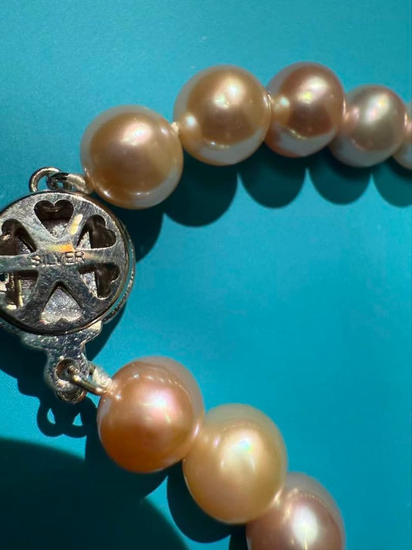 Close-up of a single lustrous Akoya pearl on a white background