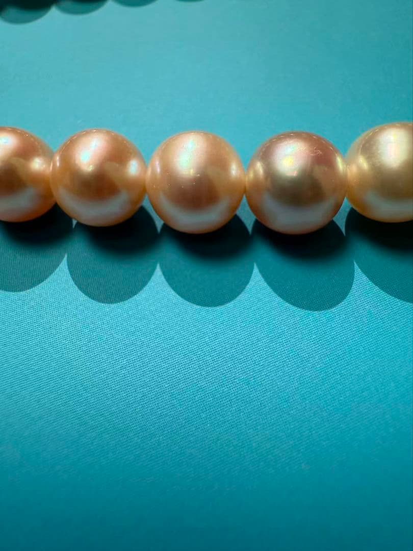 Close-up of a single lustrous Akoya pearl on a white background