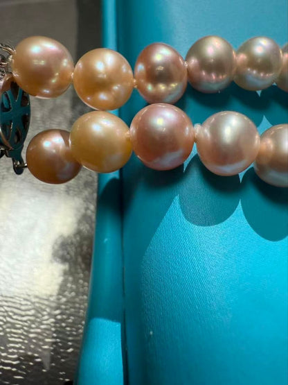 Close-up of a single lustrous Akoya pearl on a white background