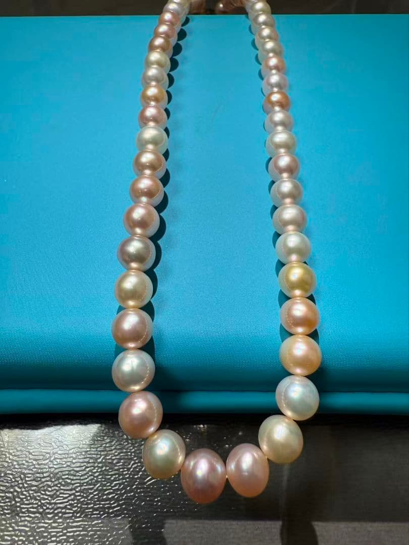Close-up of a single lustrous Akoya pearl on a white background
