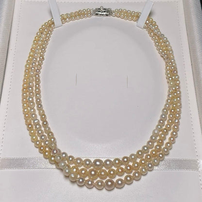 Akoya pearl triple gradient necklace with 3.4-7.3mm white semi-round pearls, 42.7cm length, silver imprint
