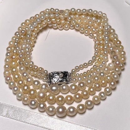Akoya pearl triple gradient necklace with 3.4-7.3mm white semi-round pearls, 42.7cm length, silver imprint