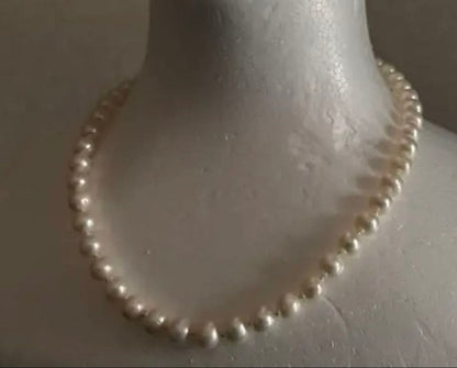 Akoya pearl round necklace with 7-7.5mm white pearls on a 44cm chain laid flat